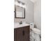 Charming half bathroom featuring a dark wood vanity and stylish patterned tile flooring at 3048 Deer Creek Ranch Loop, Parker, CO 80138