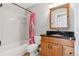 Bathroom featuring a wooden vanity, dark counter, bathtub with shower, and colorful shower curtain at 3048 Deer Creek Ranch Loop, Parker, CO 80138