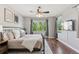 Bedroom with hardwood floors, ceiling fan, large window with a scenic view, and mounted TV at 3048 Deer Creek Ranch Loop, Parker, CO 80138
