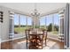 Sun-filled dining room with large windows, a chandelier, and hardwood floors at 3048 Deer Creek Ranch Loop, Parker, CO 80138