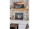 Stone fireplace with a wooden mantle and decorative accents in the living room at 3048 Deer Creek Ranch Loop, Parker, CO 80138