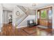 Spacious foyer showcasing hardwood floors, a staircase, and an ornate front door at 3048 Deer Creek Ranch Loop, Parker, CO 80138