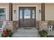Elegant front door with leaded glass, stone pillars, and decorative sconces at 3048 Deer Creek Ranch Loop, Parker, CO 80138