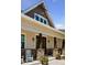 A close up of the front porch featuring natural wood columns and rocking chairs at 3048 Deer Creek Ranch Loop, Parker, CO 80138