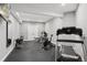 Home gym equipped with treadmill, weights, stationary bike and rubber mat flooring at 3048 Deer Creek Ranch Loop, Parker, CO 80138