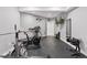 Home gym featuring rubber mat flooring, free weights, treadmill, and mounted TV at 3048 Deer Creek Ranch Loop, Parker, CO 80138
