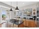 Beautiful kitchen with a center island, granite countertops, and seamless access to the living room at 3048 Deer Creek Ranch Loop, Parker, CO 80138
