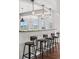 Stylish kitchen bar features pendant lighting and seating for casual dining and entertaining at 3048 Deer Creek Ranch Loop, Parker, CO 80138