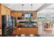 Spacious kitchen with hardwood floors, modern appliances, and views of the outdoors at 3048 Deer Creek Ranch Loop, Parker, CO 80138
