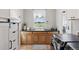 Laundry room with counter space, wooden cabinets, a sink, and modern washer and dryer at 3048 Deer Creek Ranch Loop, Parker, CO 80138