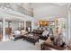 Open-concept living room with soaring ceilings, connecting seamlessly to the kitchen and dining areas at 3048 Deer Creek Ranch Loop, Parker, CO 80138