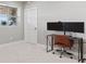 Home office with carpet, window, and a modern desk with dual monitors at 3048 Deer Creek Ranch Loop, Parker, CO 80138