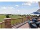 A view from the covered stone-pillared patio to the open land beyond the property at 3048 Deer Creek Ranch Loop, Parker, CO 80138