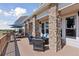 Covered patio area showing the stone columns and outdoor seating with view to the yard at 3048 Deer Creek Ranch Loop, Parker, CO 80138