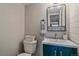 Updated bathroom features a stylish vanity, modern fixtures and a chic blue cabinet at 2293 S Oswego Way, Aurora, CO 80014