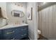 Elegant bathroom with a navy blue vanity, gold accents, and a spacious shower at 2293 S Oswego Way, Aurora, CO 80014