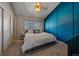 Main bedroom with a teal accent wall and ceiling fan at 2293 S Oswego Way, Aurora, CO 80014