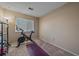 Bright bedroom with a Peloton exercise bike, and a yoga mat at 2293 S Oswego Way, Aurora, CO 80014