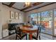 Dining area with wood table and chairs, access to backyard patio at 2293 S Oswego Way, Aurora, CO 80014