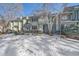 Snow-covered front yard of a charming two-story townhome at 2293 S Oswego Way, Aurora, CO 80014