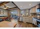 Updated kitchen with wood beams, stainless steel appliances, and stylish backsplash at 2293 S Oswego Way, Aurora, CO 80014