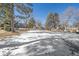 Snowy, open green space with trees and homes in background at 2293 S Oswego Way, Aurora, CO 80014