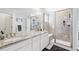 Main bathroom with double vanity, granite countertops and a shower at 8373 Rush Creek Ave, Littleton, CO 80125