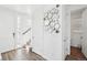 Bright entryway with wood floors, a powder room, and a stylish mirror at 8373 Rush Creek Ave, Littleton, CO 80125