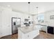 Modern kitchen featuring stainless steel appliances and a large kitchen island at 8373 Rush Creek Ave, Littleton, CO 80125