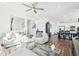 Open concept living room and kitchen with hardwood floors and lots of natural light at 8373 Rush Creek Ave, Littleton, CO 80125