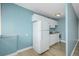 A compact kitchen features white cabinets, a white refrigerator, and a light fixture at 1196 N Grant St # 705, Denver, CO 80203