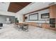 Bright and spacious conference room with a long wooden table, kitchen, and large screen at 891 14Th St # 2703, Denver, CO 80202