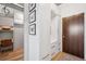 Entryway with closet and white built-ins adjacent to a wooden door and light hardwood flooring at 891 14Th St # 2703, Denver, CO 80202