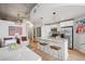 Open kitchen with a marble-topped island, pendant lights, and stainless-steel appliances flows into a living area at 891 14Th St # 2703, Denver, CO 80202