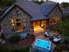 Stone house featuring a patio with outdoor furniture, hot tub, and a fire pit at 6840 Northstar Cir, Castle Rock, CO 80108
