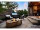 Relaxing backyard with stone fire pit, plush seating, and a hot tub perfect for outdoor enjoyment at 6840 Northstar Cir, Castle Rock, CO 80108