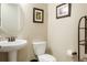 Powder room with pedestal sink, and decorative art and fixtures at 6840 Northstar Cir, Castle Rock, CO 80108