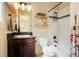 Bathroom featuring a toilet, vanity and shower with an open storage shelf and unique patterned shower curtain at 6840 Northstar Cir, Castle Rock, CO 80108