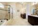 Bright bathroom featuring a soaking tub, shower, and double vanity at 6840 Northstar Cir, Castle Rock, CO 80108