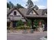 The community entrance features beautiful stone architecture, colorful flowers, and a landscaped roundabout at 6840 Northstar Cir, Castle Rock, CO 80108