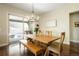 Bright dining room with modern chandelier and access to outdoor hot tub area through sliding glass door at 6840 Northstar Cir, Castle Rock, CO 80108