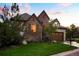 Beautiful stone and stucco home with a well-kept lawn and mature trees enhancing its appeal at 6840 Northstar Cir, Castle Rock, CO 80108