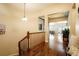 Upstairs hallway with hardwood floors, wood banister and views of the open floor plan at 6840 Northstar Cir, Castle Rock, CO 80108
