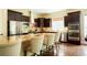 Modern kitchen with granite countertops, stainless steel appliances, and dark wood cabinets at 6840 Northstar Cir, Castle Rock, CO 80108