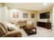 Cozy living room with plush sectional sofa, coffee table, and entertainment center with large screen TV at 6840 Northstar Cir, Castle Rock, CO 80108