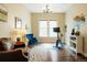 Bright room featuring hardwood floors, large windows, and comfortable seating at 6840 Northstar Cir, Castle Rock, CO 80108