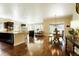 Open concept living space featuring hardwood floors, a fireplace, and abundant natural light at 6840 Northstar Cir, Castle Rock, CO 80108