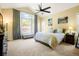 Bright main bedroom featuring a ceiling fan and a large window with natural light at 6840 Northstar Cir, Castle Rock, CO 80108