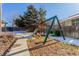 Landscaped backyard with playset and walkway at 4460 S Himalaya Ct, Aurora, CO 80015