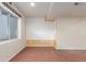 Unfinished basement room with an accent wall and a window at 4460 S Himalaya Ct, Aurora, CO 80015